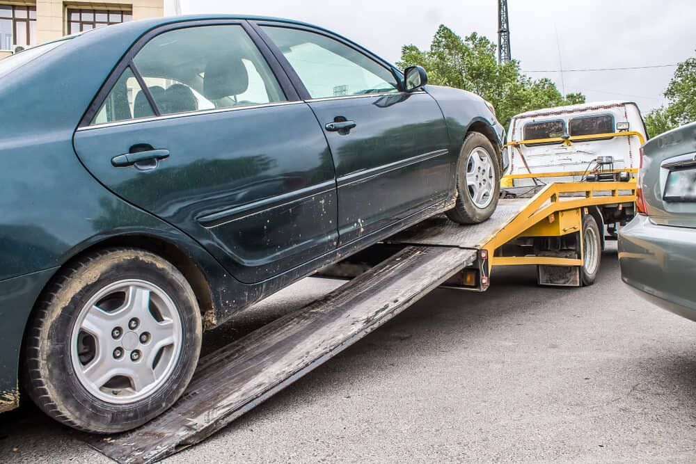 A Car Is Being Towed By A Tow Truck — Wilson's Towing In Westbrook, QLD