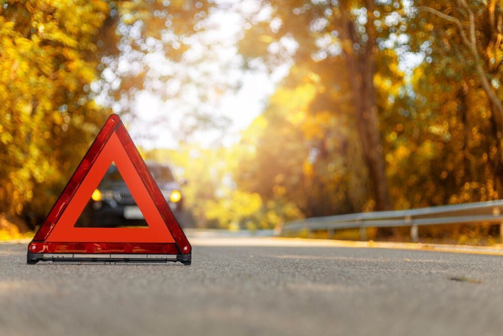 A Red Warning Triangle Is Sitting On The Side Of A Road — Wilson's Towing In St George, QLD