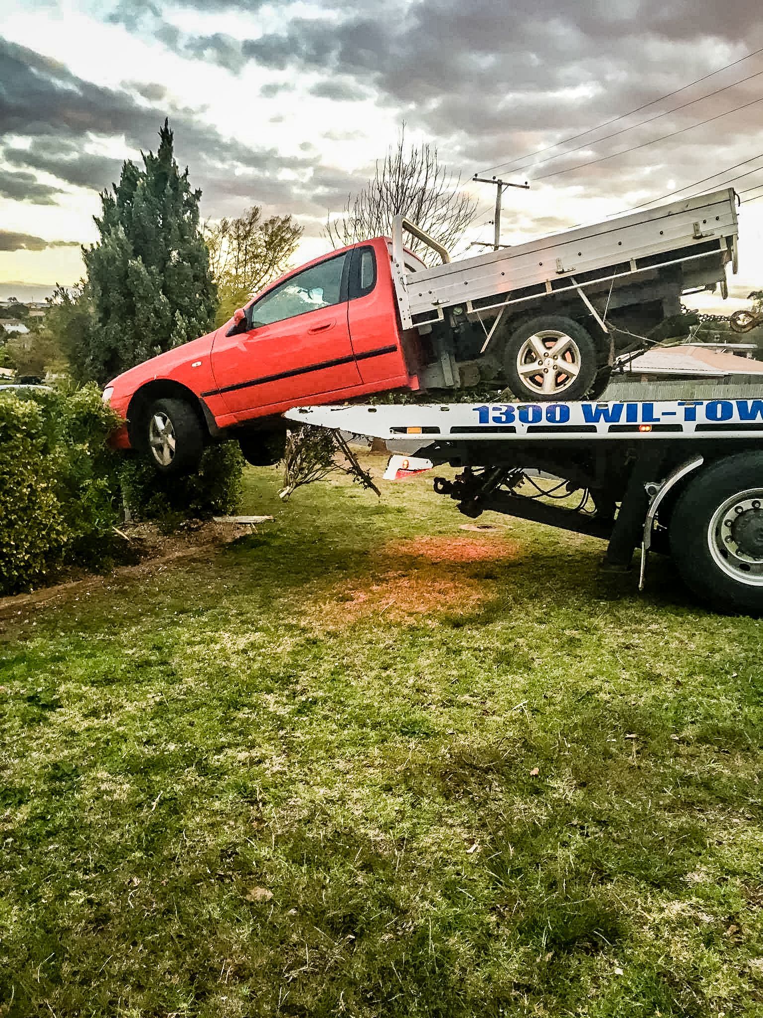 A Tow Truck With A Red Jeep On The Back Of It — Wilson's Towing In Nambour, QLD
