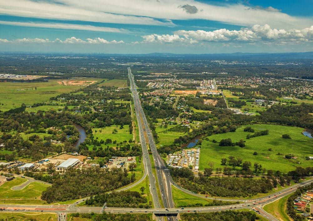 An Aerial View Of A Highway Going Through A Lush Green Countryside — Wilson's Towing In Caboolture, QLD