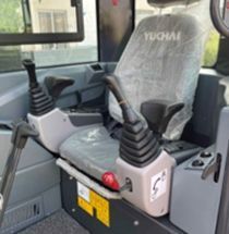 Interior of a YYUCHAI U35 excavator cab with joysticks, seat, and controls.