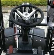 YUCHAI Z25 Black steering wheel and pedals inside a small vehicle.