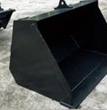 Black metal bucket, likely for construction or excavation, with a handle on top, resting on concrete.