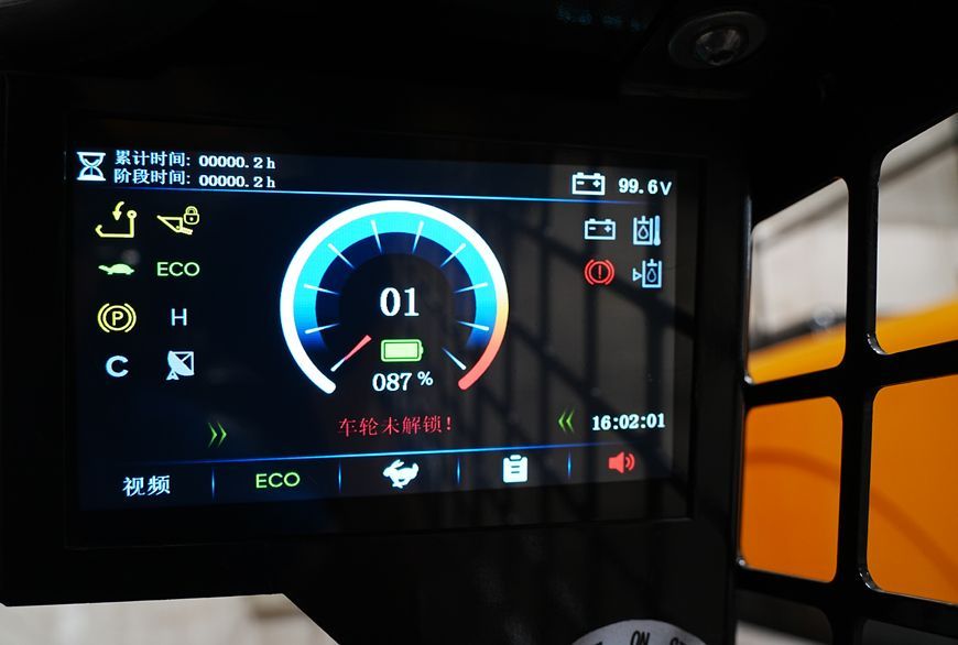 Dashboard display in a vehicle showing speed gauge, battery and warning lights.