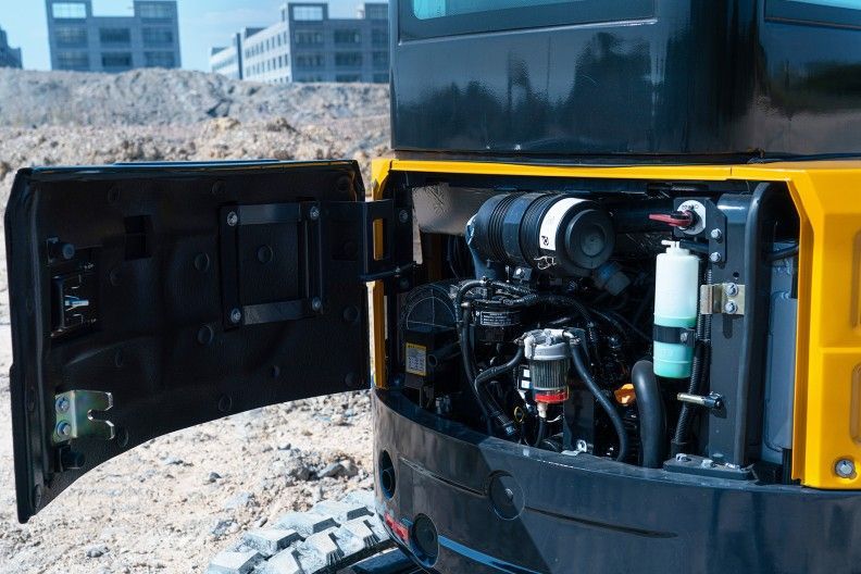 YUCHAI U35 Excavator engine compartment, door open. Black, yellow, and silver components visible.