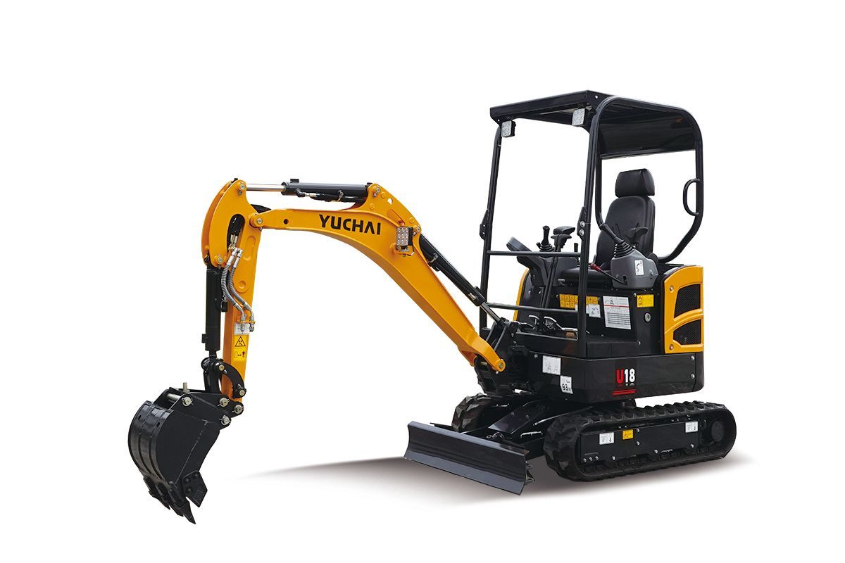 Yellow and black YUCHAI U18 mini excavator on tracks, digging in a white space.