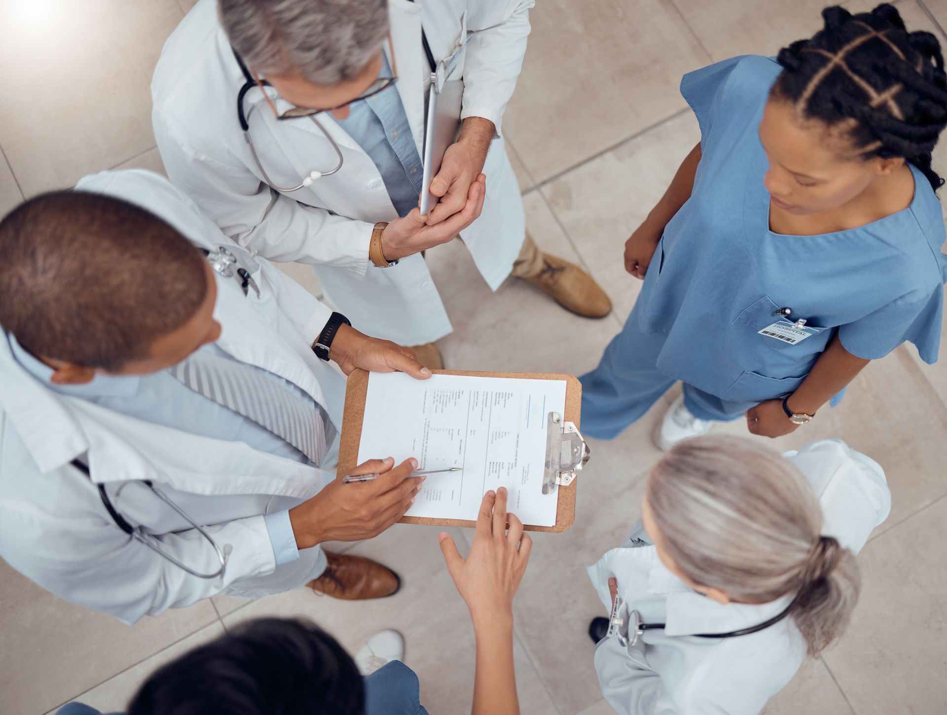Medical team reviewing a chart, discussing patient care in a hospital setting.