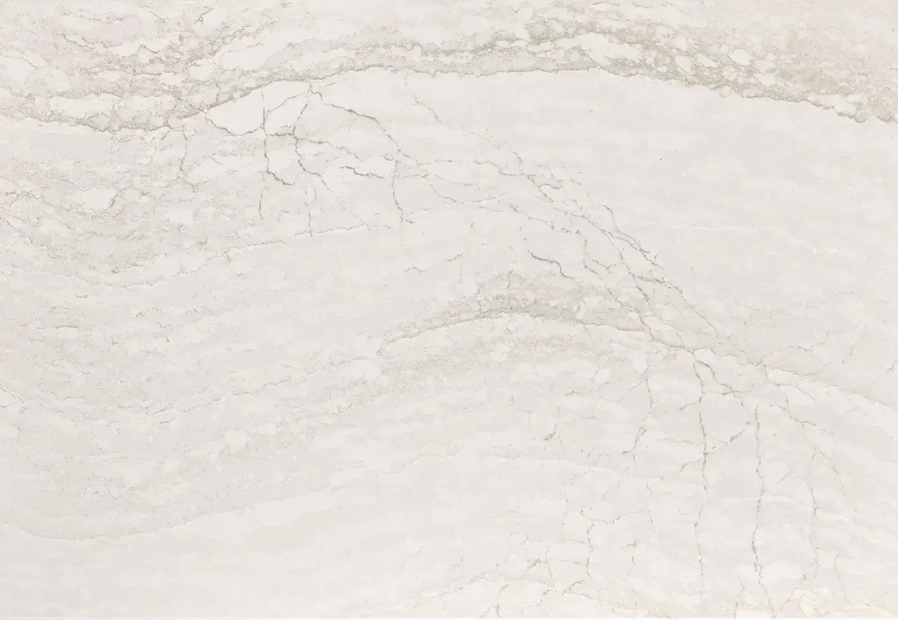 White marble countertop with swirling grey and beige veining.