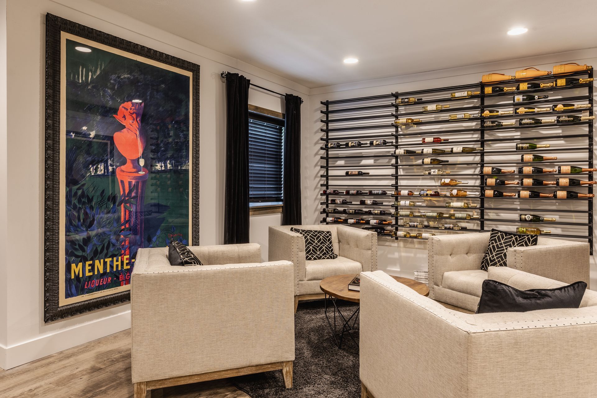 Basement recreation room with pool table, seating area, and wall art overlooking a TV.