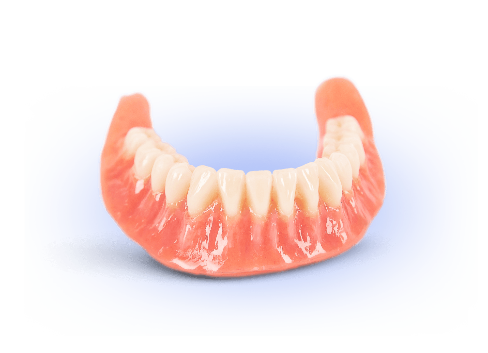 A close up of a denture on a white surface.