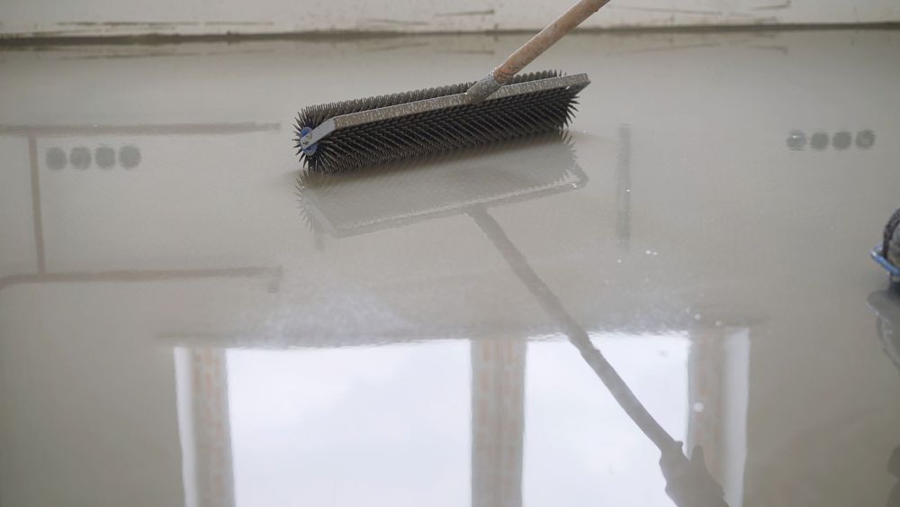 Mop on a glossy floor reflecting a window and doorway