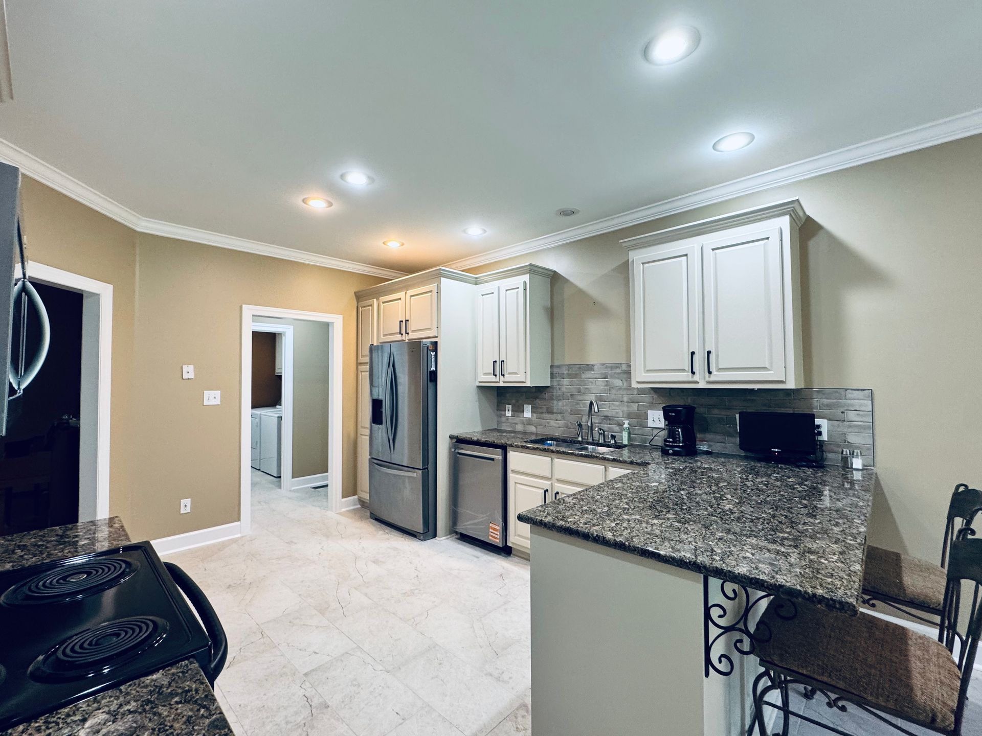 Quartz countertop and shaker cabinet hardware detail in a newly remodeled Fayetteville TN kitchen by Proverbs Construction.