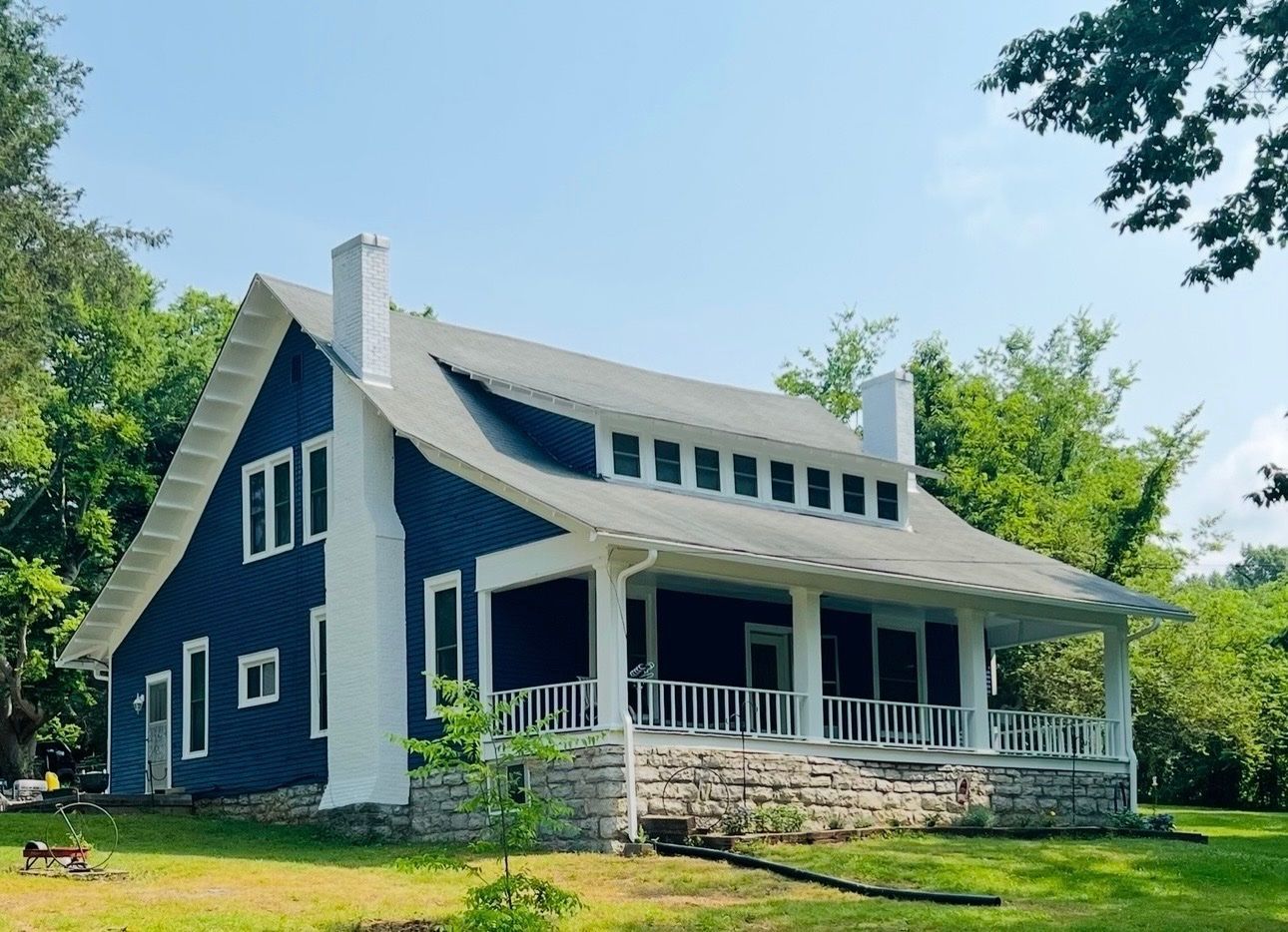 Exterior house painting with fresh white paint and dark trim on a home in Fayetteville, TN