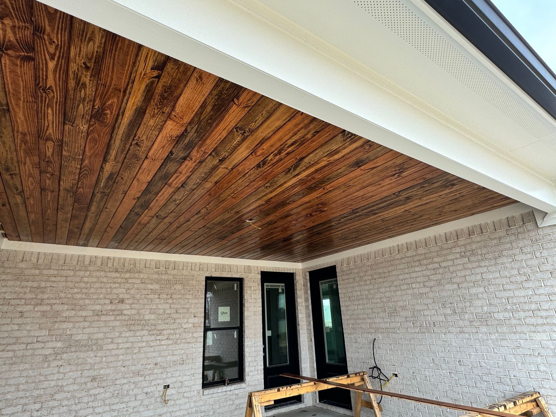 Renovated residential porch with new decking and railings on a Fayetteville, TN home - Proverbs Construction.
