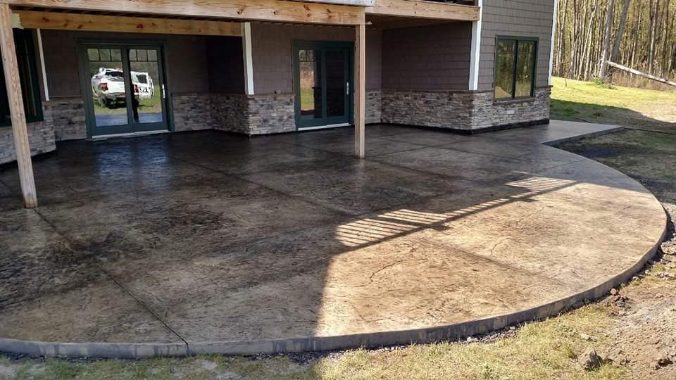 A large concrete patio in front of a house.