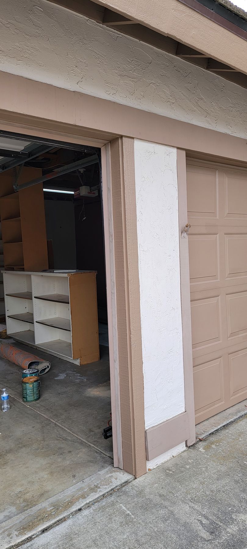 A garage door is being painted in a house.