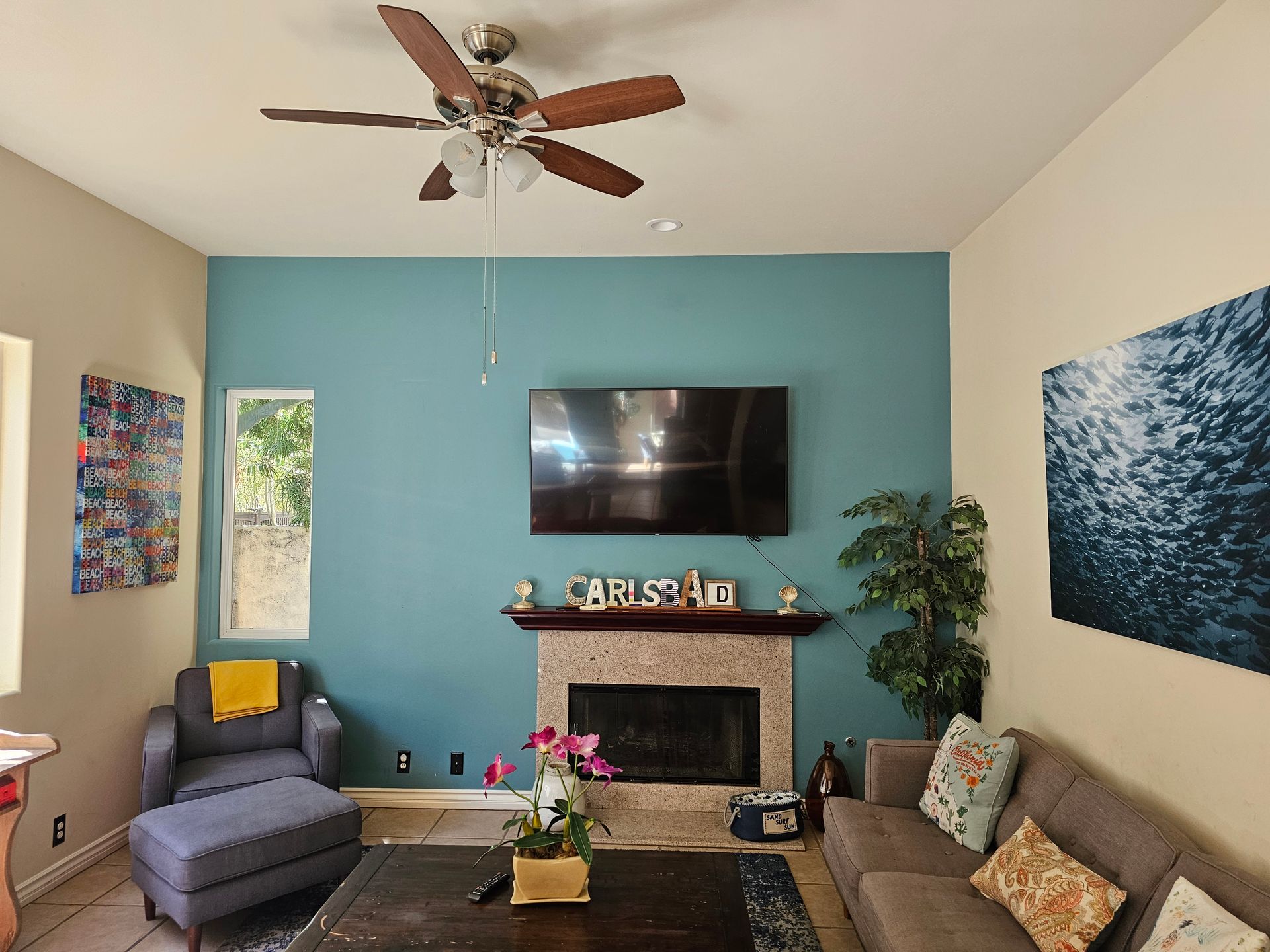 A living room with a fireplace and a flat screen tv