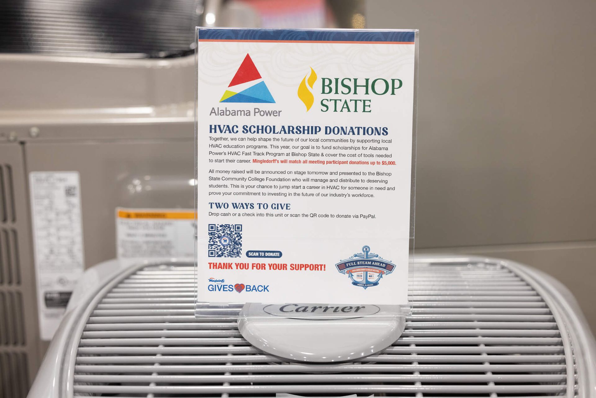Bishop State brochure standing on an air conditioner unit in a classroom or office setting