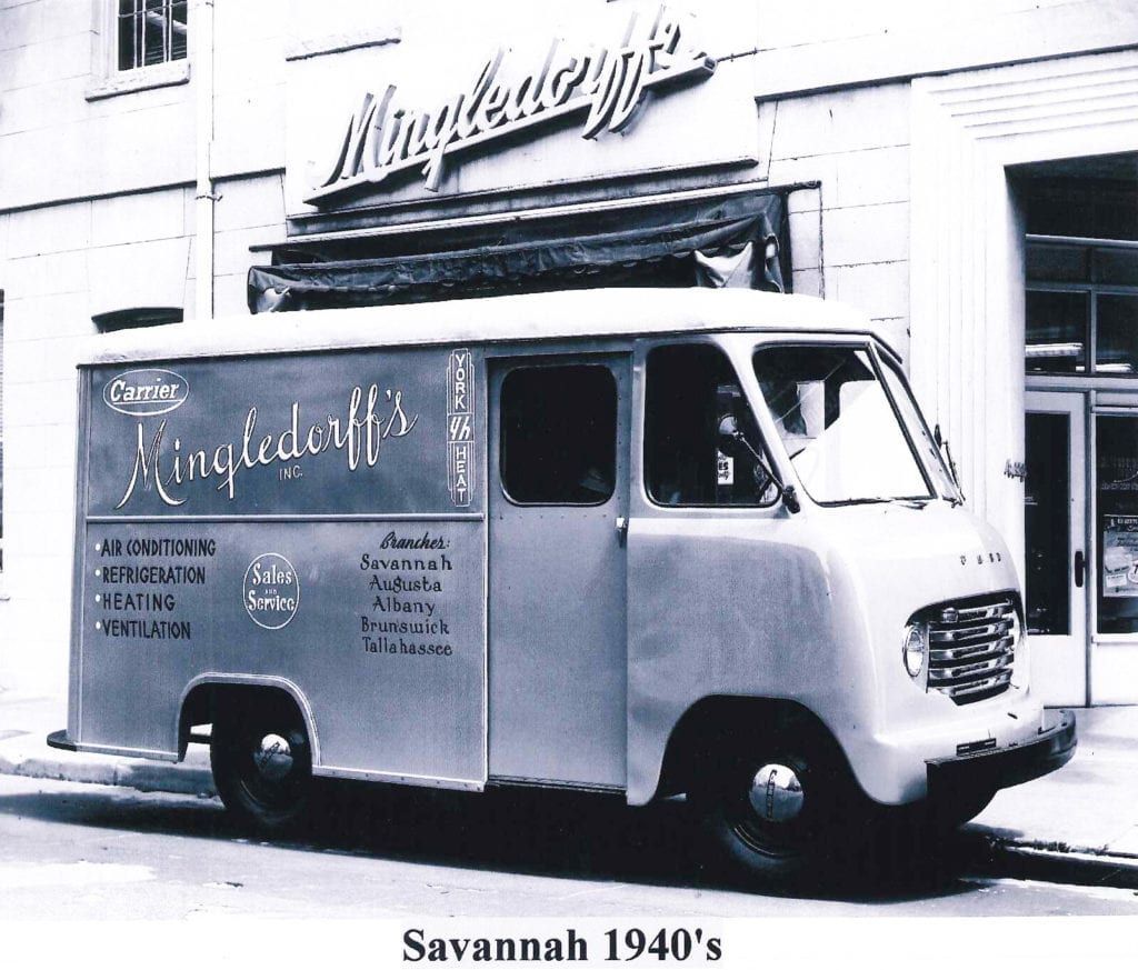 Black-and-white delivery van parked outside a storefront, labeled Savannah 1940's