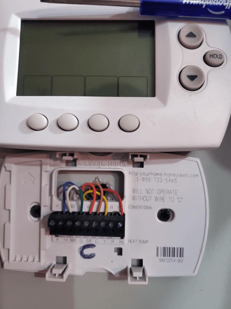 Open thermostat with exposed wiring and display screen at top