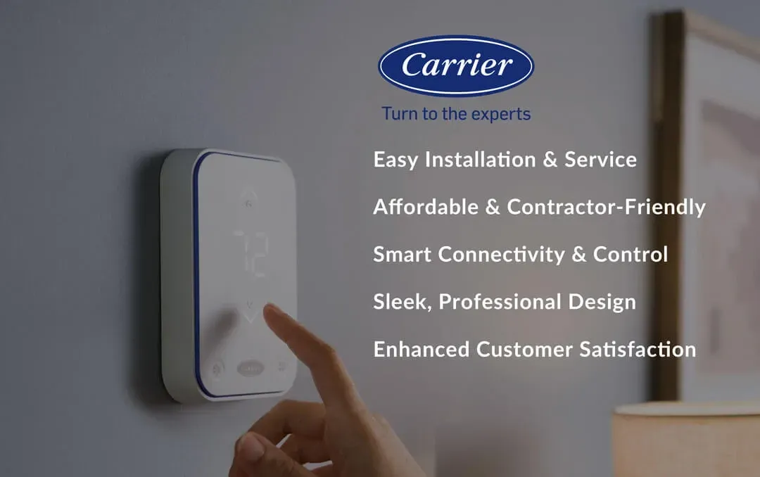 Carrier smart thermostat with hand adjusting it and feature text on a gray wall