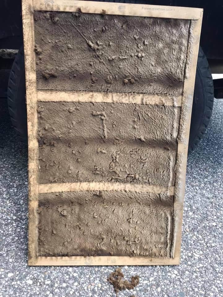 Dirty wooden crate with three horizontal slats, viewed from the open back side.