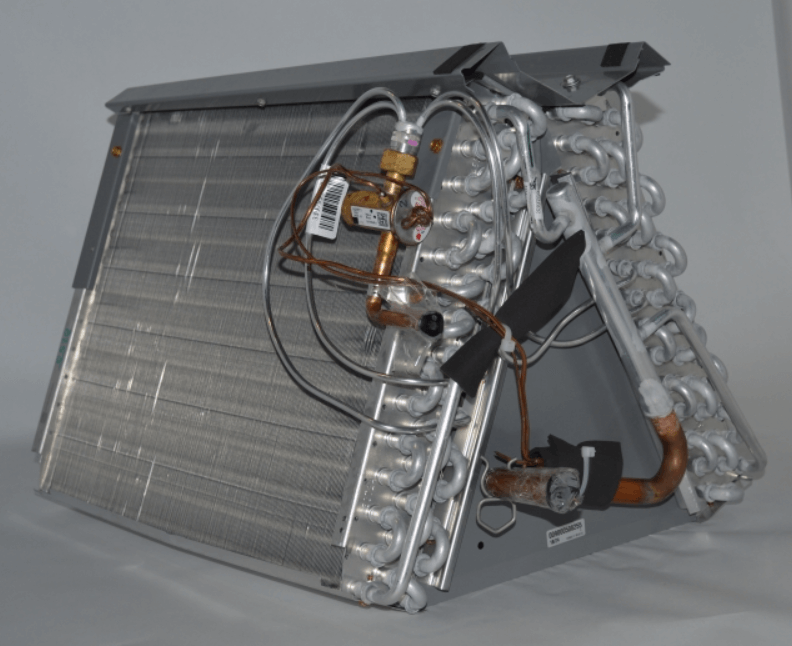 Automotive heater core and aluminum cooling coil assembly with attached hoses and fittings on a gray background