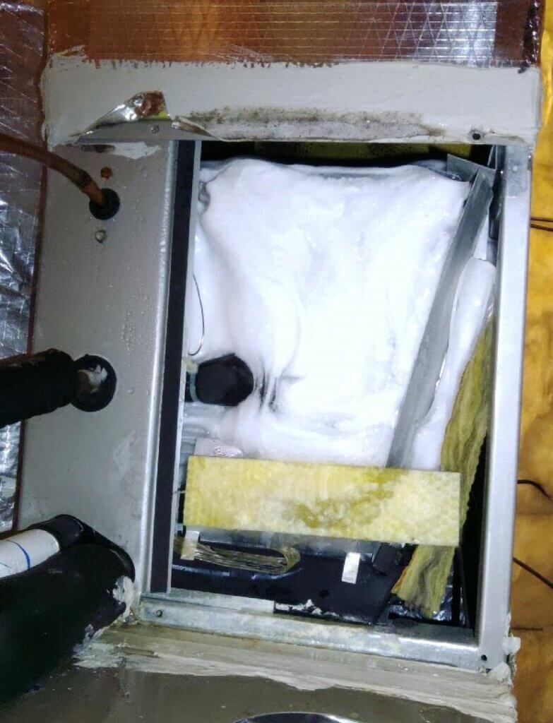 Open electrical panel with white insulation and black cables inside a metal box.