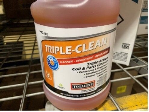 Triple-Clean cleaning solution bottle with orange label on a store shelf
