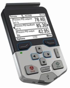 Handheld electronic meter with LCD display and keypad, showing live process readings.