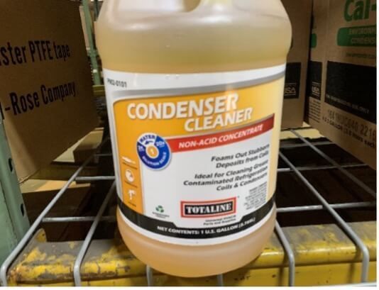 Bottle of orange condenser cleaner on a store shelf, labeled 