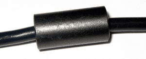 Black cable with a cylindrical ferrite choke in the center