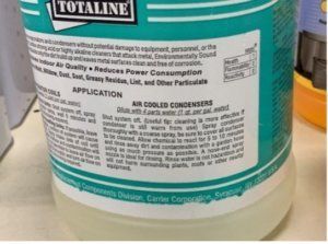 Close-up of a teal Totaline air conditioner cleaner can with product label text.
