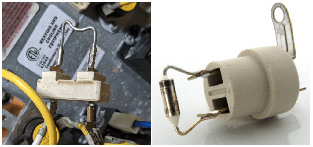 Close-up of a white automotive fuse holder with metal clips beside car wiring harnesses