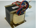 Small electrical transformer with red and blue wires mounted on a metal frame