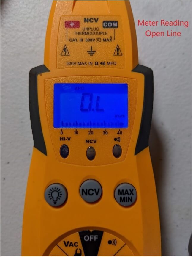 Close-up of a yellow digital meter with blue screen reading “OL,” next to red text “Meter Reading Open Line.”