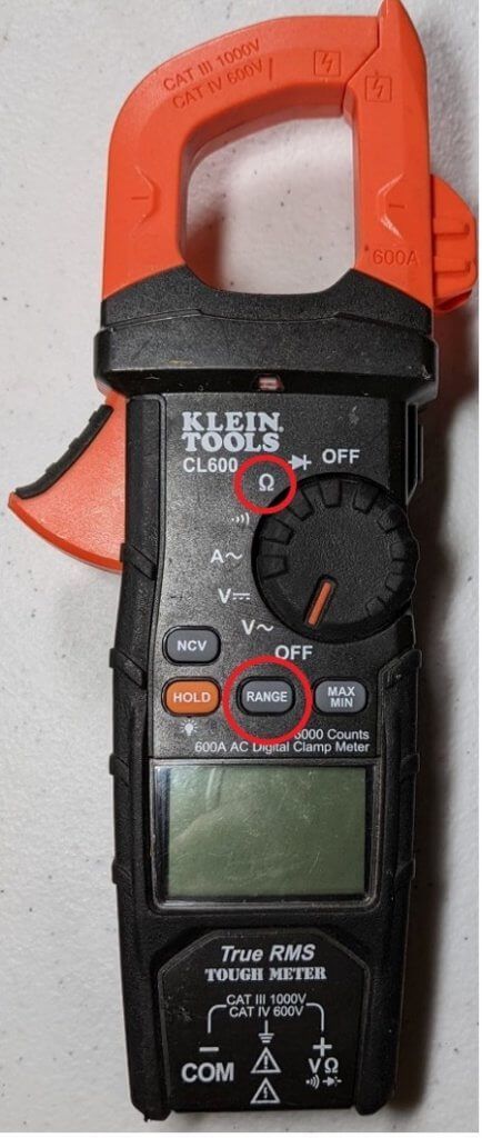 Digital clamp multimeter with orange jaws and red-circled controls on a white background