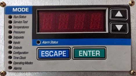Close-up of a machine control panel with red display, mode list, and ESCAPE and ENTER buttons