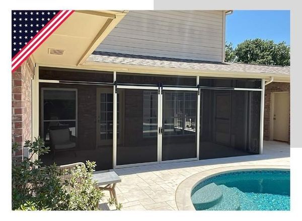 Screened-in patio with sliding doors next to a pool. Building is brick and tan.