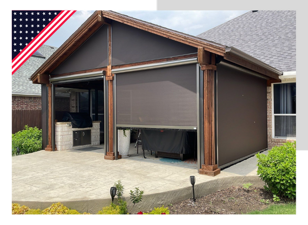 Brown outdoor structure with retractable shades, on a patio, with US flag.
