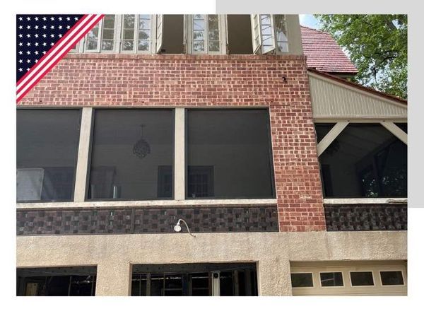 Building facade with brick, windows, and American flag overlay.