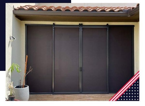 Brown outdoor sun shades on a patio, with a terracotta roof above.