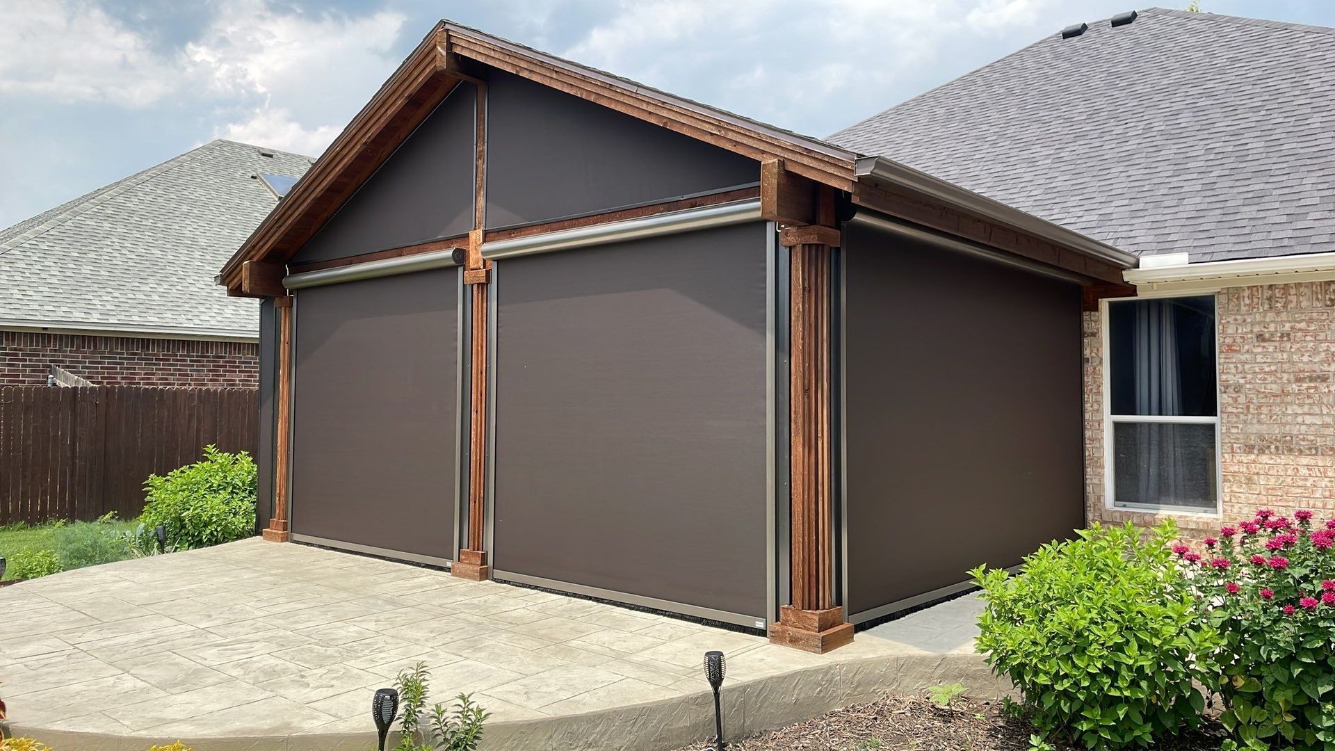 Brown outdoor shade covers a patio structure with wooden beams.