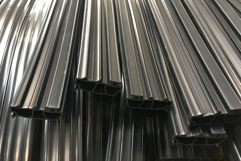 A Stack of Dark, Metallic Extruded Industrial Profiles Showing a Hollow — JNL Crankshaft Services in Palmerston City, NT