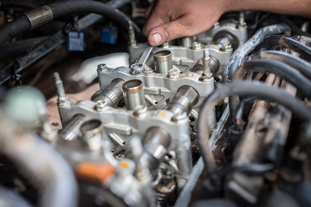 A Person Uses a Wrench to Adjust Internal Engine Components — JNL Crankshaft Services in Palmerston City, NT