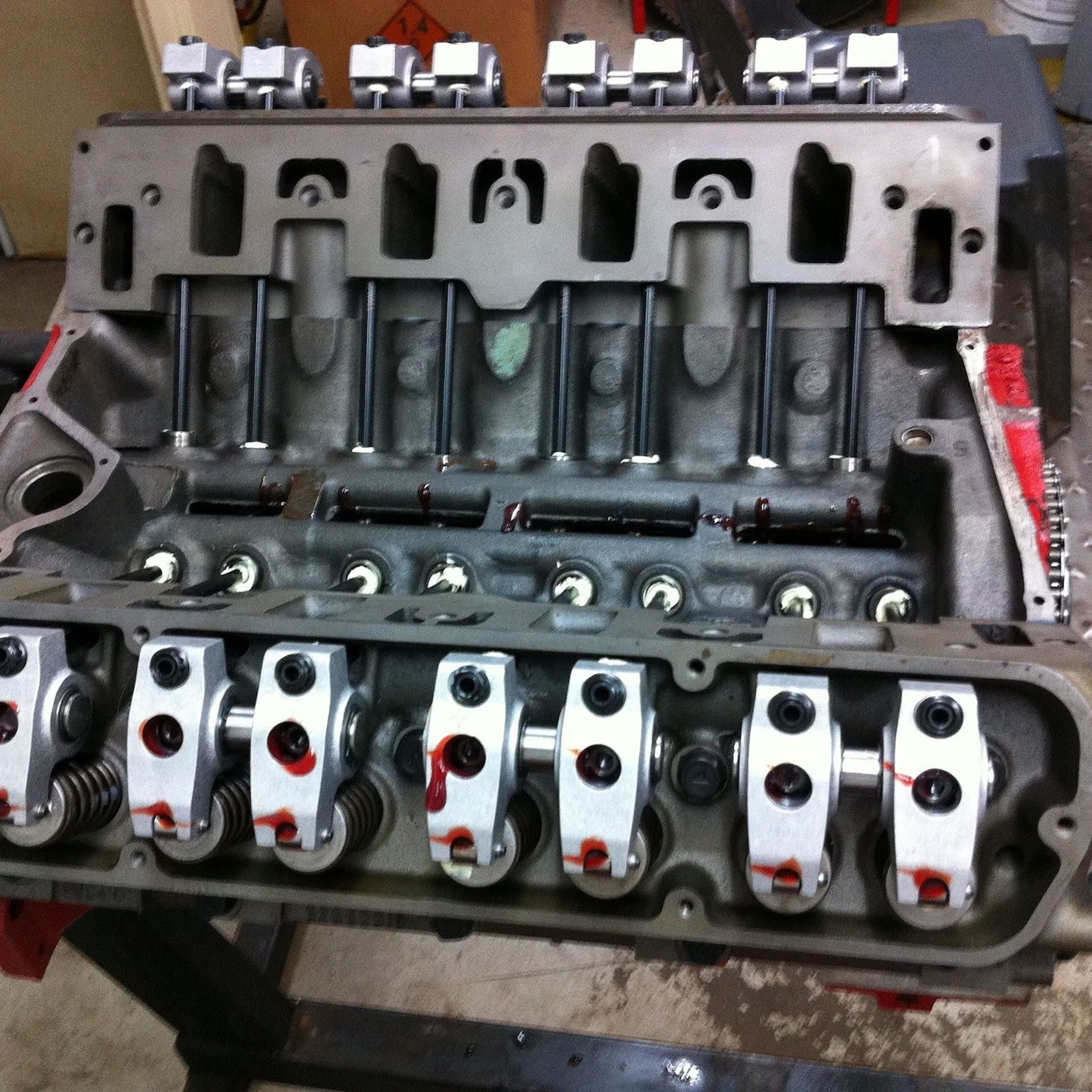 A close-up of a partially assembled V8 engine block, showing the valve train with rocker arms and pushrods in place. — JNL Crankshaft Services in Palmerston City, NT