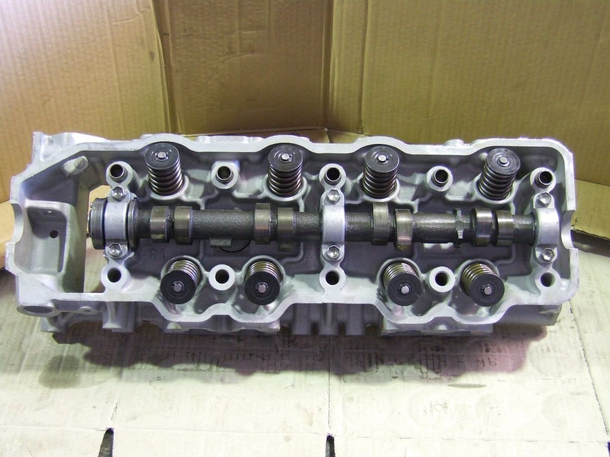 A Hydraulic Cylinder Arm Attached to the Dark Grey Metal Frame — JNL Crankshaft Services in Palmerston City, NT
