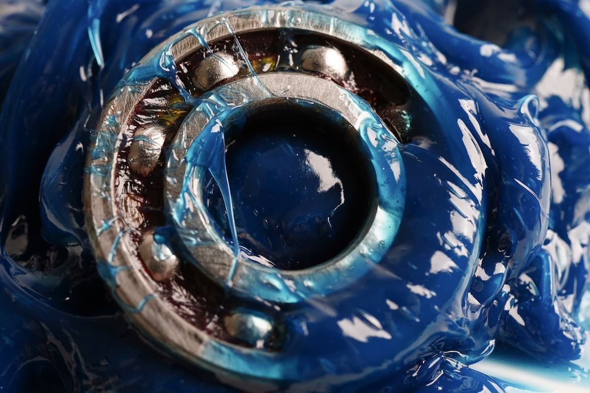 A Silver Ball Bearing is Coated in Thick, Vibrant Blue Industrial Grease — JNL Crankshaft Services in Palmerston City, NT