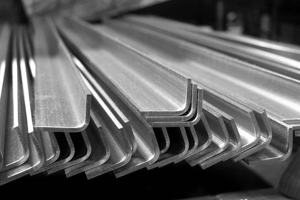 Black-and-white View of a Stack of L-shaped Metal Angle Bars — JNL Crankshaft Services in Palmerston City, NT