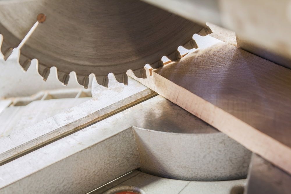 A Circular Saw Blade Positioned to Cut Through a Piece of Wood — JNL Crankshaft Services in Palmerston City, NT